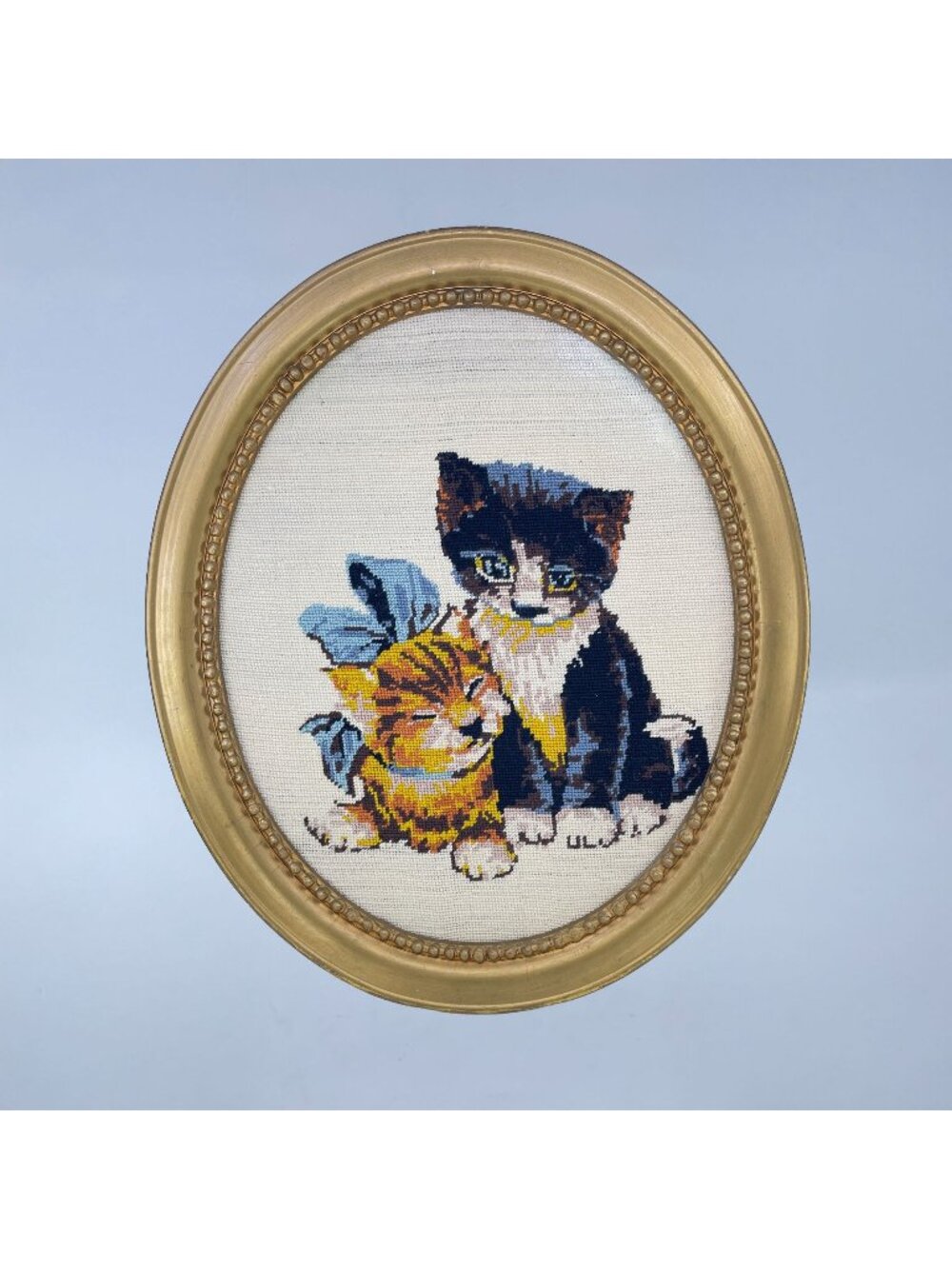 vintage hand-stitched needlepoint kitten artwork in gold oval frame